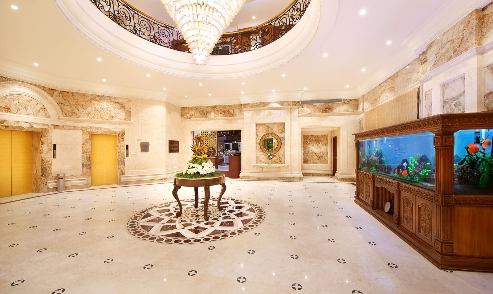 Expansive lobby at Accord Hotels and Resorts featuring elegant interiors, wooden tables, cushioned seating, chandeliers, and soft, inviting lighting.